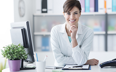 Female receptionist smiling at her desk