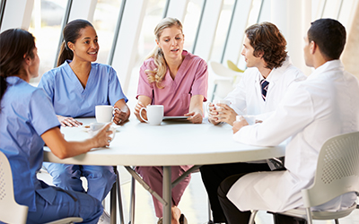 A group of people sitting at a table talking