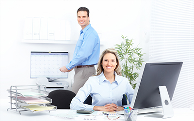 A business woman sitting at a desk smiling