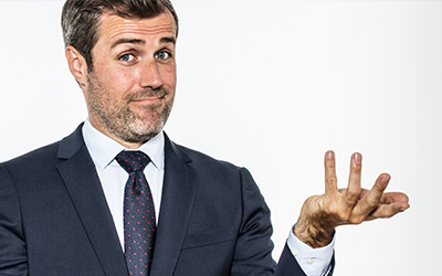 Man in a suit shrugging with questionable look on his face