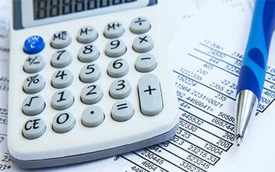 A calculator sitting on financial reporting paperwork