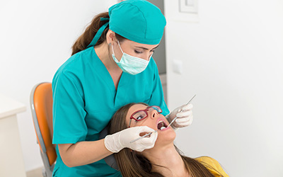 Hygienists cleaning patient