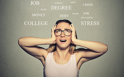 Woman who is stressed with stressful subjects surrounding her