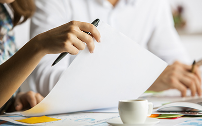 Two people working on paperwork together