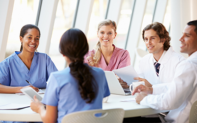 Medical employees meeting around a table and discussing with each other