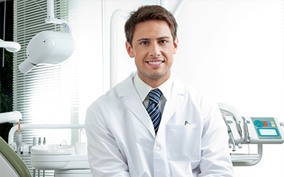 An image of a male dentist